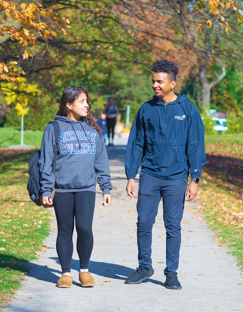 Two Mercy University students walking and talking on the Westchester Campus