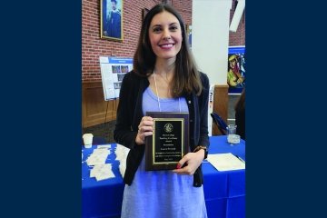Professor holding award