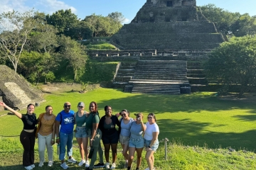 Mercy University students in front of a pyramid in Belize
