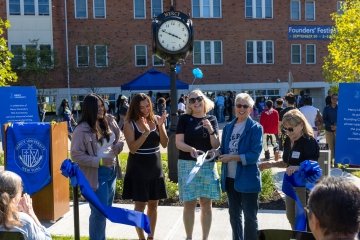 Mercy University president, faculty and student cut the ribbon for the new clock dedicated during Founders' Festival 2025 in honor of the 75th anniversary