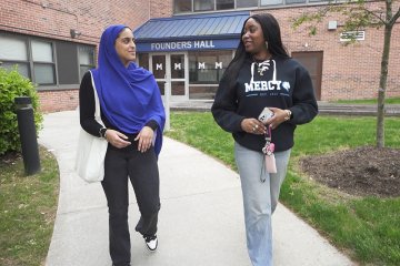Mercy University students walking from Founders Hall in the Westchester Campus
