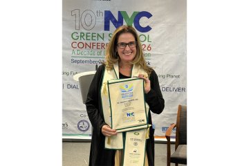 Dr. Meghan Marrero holding Beacon of Blue Award