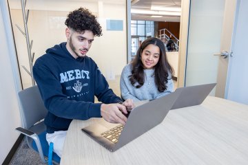 Mercy University students on their laptops