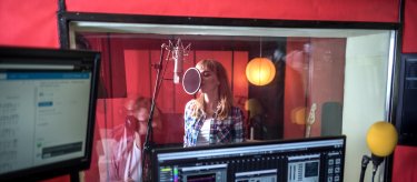 woman singing in recording studio