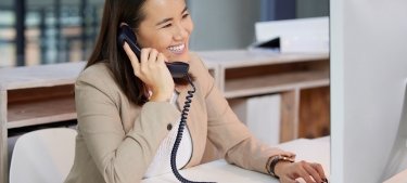 Woman speaking on phone at desk