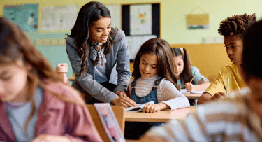 Teacher in Classroom with Young Student