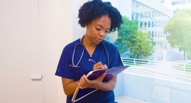 student nurse taking notes