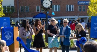 Mercy University president, faculty and student cut the ribbon for the new clock dedicated during Founders' Festival 2025 in honor of the 75th anniversary
