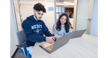 Mercy University students on their laptops