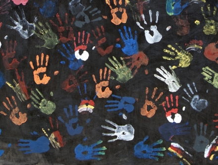 Multi-colored handprints representing the nation's of the world.