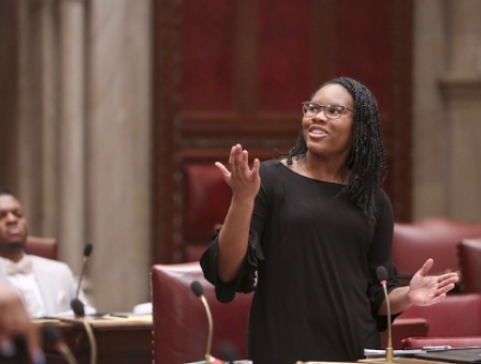 Woman in black dress in NY Legislature