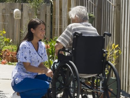 Nurse attending to senior in wheelchair