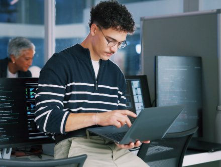 cybersecurity expert working on laptop