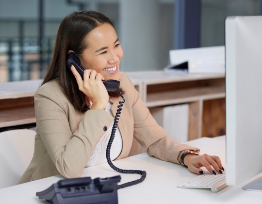 Woman speaking on phone at desk
