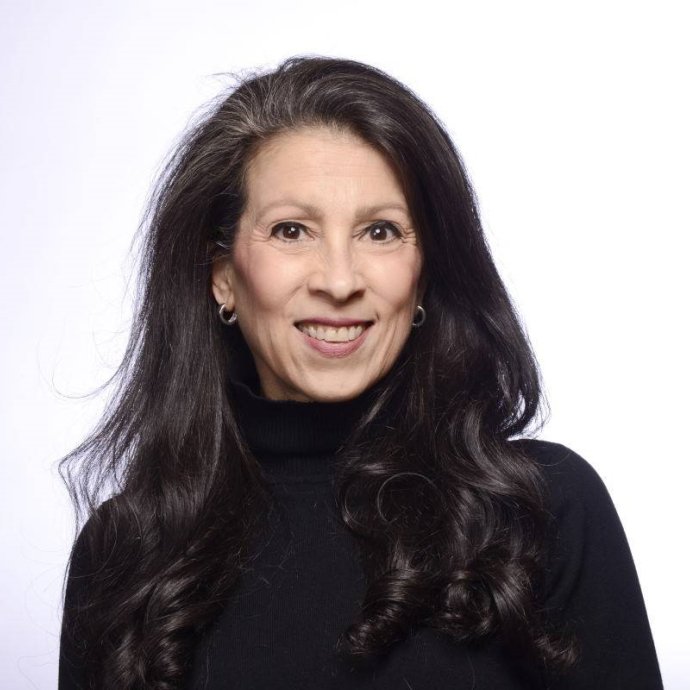 Photo of Wendy K. Mages wearing a black turtleneck