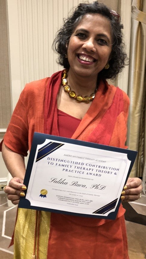 Mercy University Professor Saliha Bava poses with her 2023 AFTA Distinguished Contribution to Family Therapy Theory and Practice Award 
