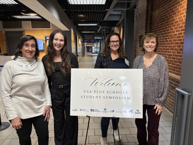 Mercy University faculty with colleagues at the USA Blue Schools Student Symposium