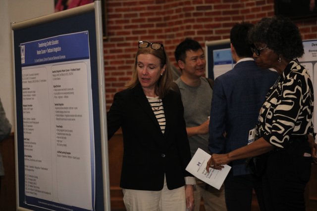 Faculty check out the poster presentations at 2026 Faculty Recognition Ceremony
